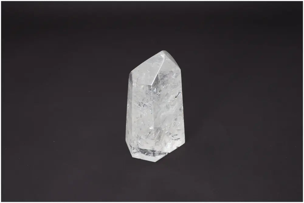 Lemurian Quartz Obelisk for chakra healing and energetic balance against black background.