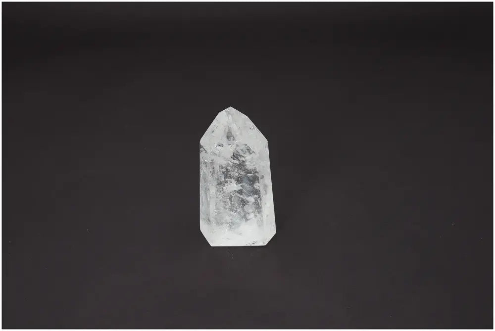 Lemurian Quartz Obelisk on a dark background, promoting chakra healing and enhancing spiritual energy.