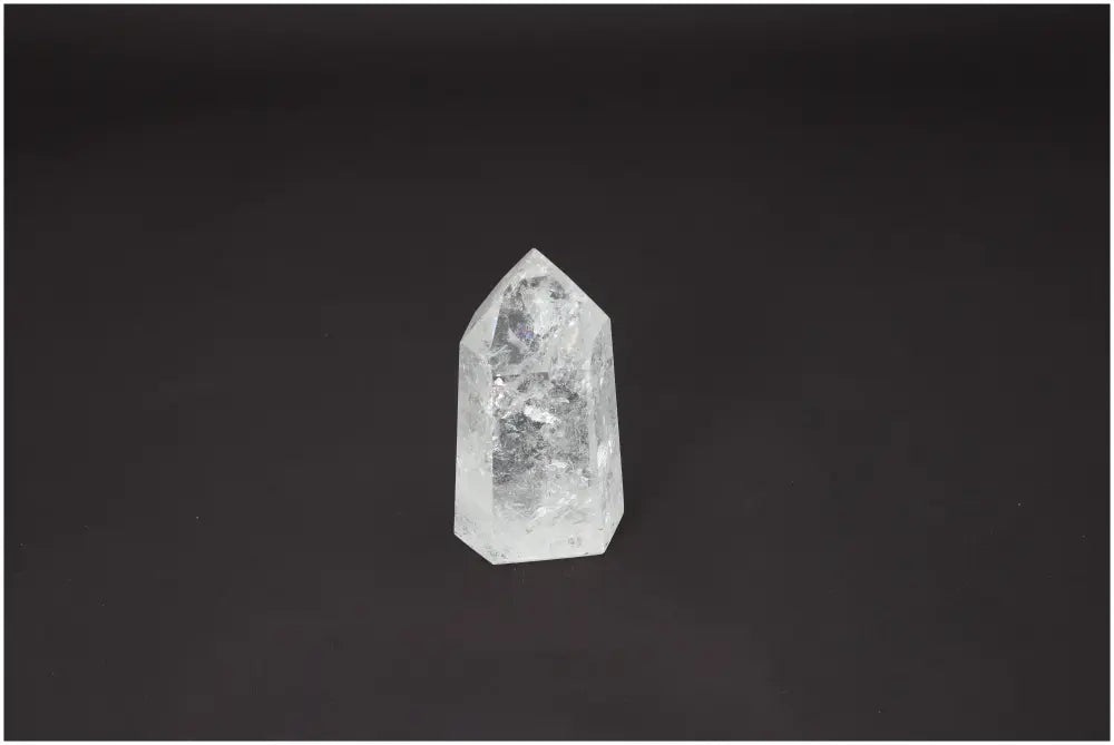 Lemurian Quartz Obelisk against a black background, showcasing its unique properties related to chakras and zodiac signs.