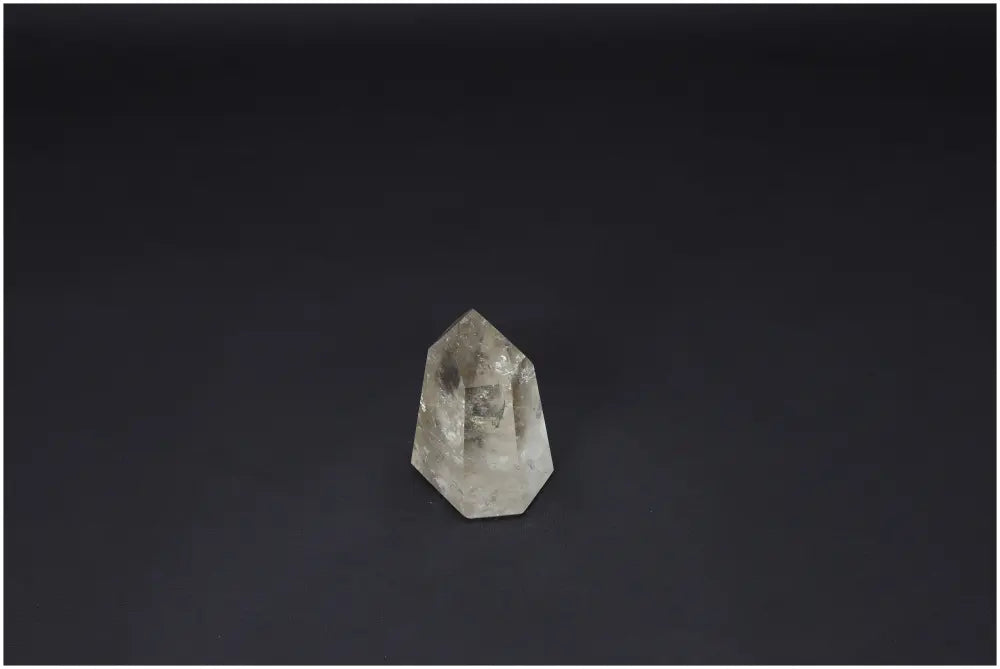 Lemurian Quartz Obelisk against dark background, showcasing unique crystal clarity and energy properties for chakra and zodiac alignment.
