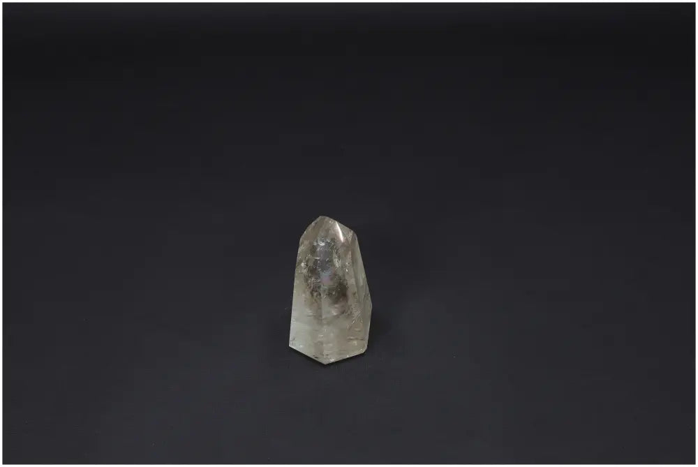 Lemurian Quartz Obelisk against a dark background, showcasing unique properties and spiritual connections with chakras and zodiac signs.