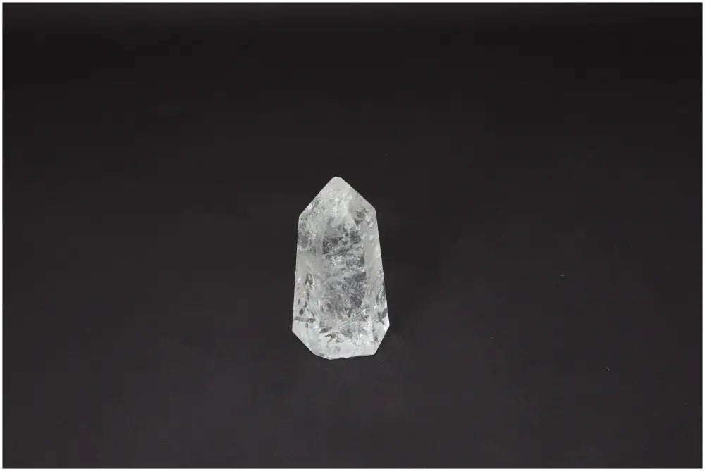 Lemurian Quartz Obelisk on dark background, showcasing its unique crystal structure and spiritual properties for chakra healing.
