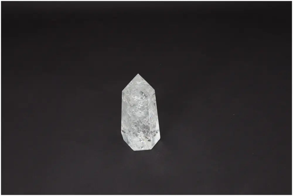 Lemurian Quartz Obelisk against a dark background showcasing its spiritual and energetic properties. Ideal for chakras and zodiac energies.