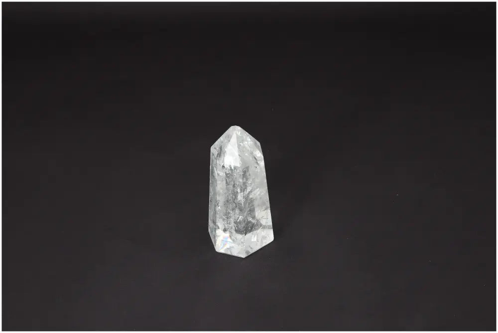 Lemurian Quartz Obelisk on dark background, showcasing unique crystal properties for chakra and zodiac energy alignment.