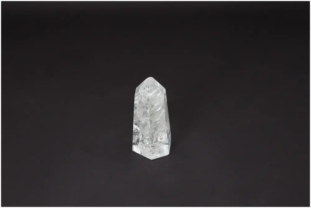Lemurian Quartz Obelisk on black background, highlighting its spiritual properties and unique crystal structure.