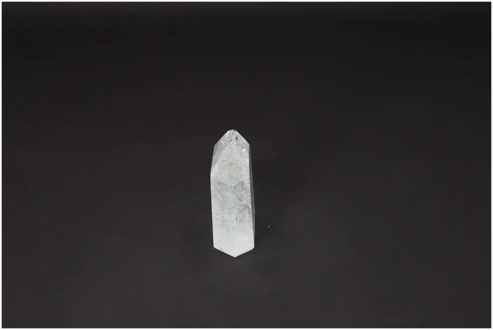 Lemurian Quartz Obelisk on black background, showcasing its unique crystal properties for chakra and zodiac sign alignment.