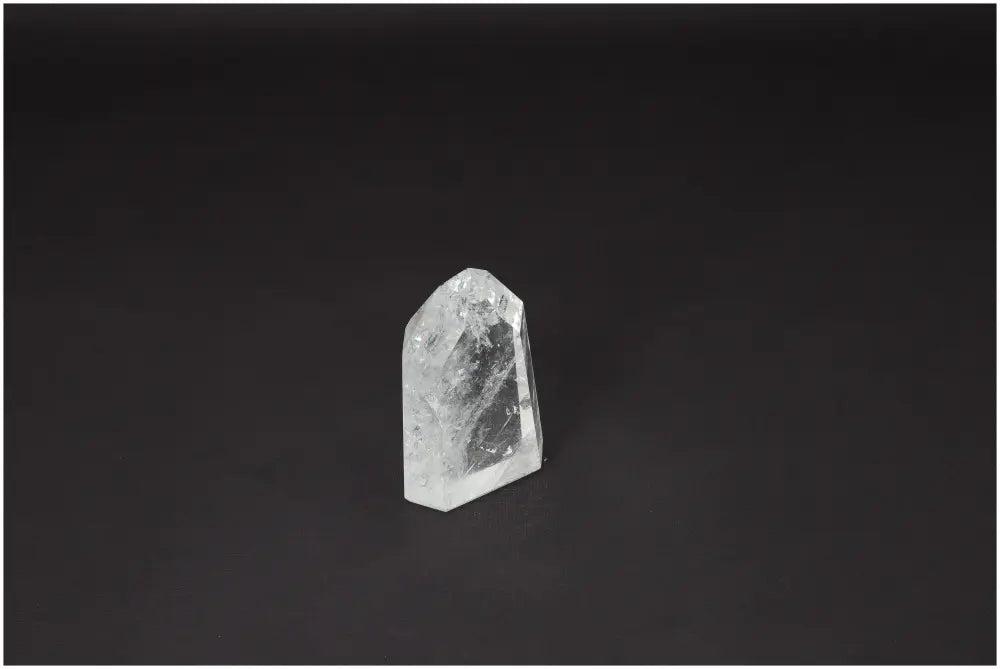 Lemurian Quartz Obelisk against dark background, highlighting unique spiritual properties for chakra balance and zodiac energy support.