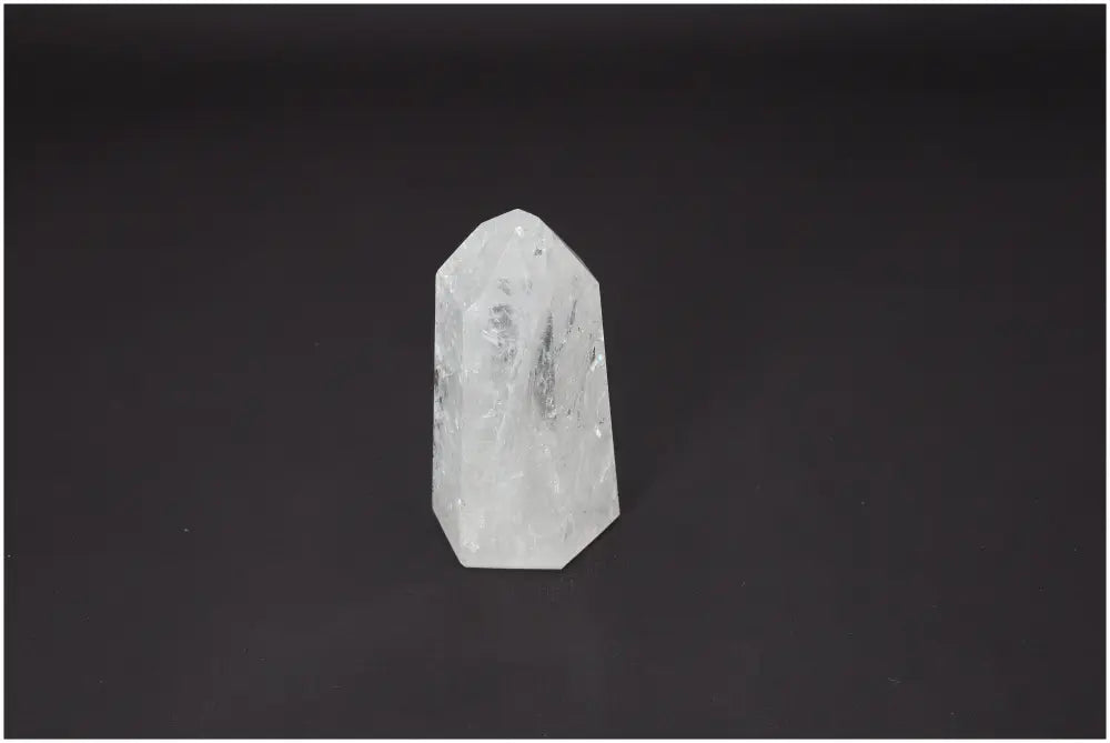 Lemurian Quartz Obelisk on a dark background, showcasing its unique properties for chakra alignment and spiritual enhancement.