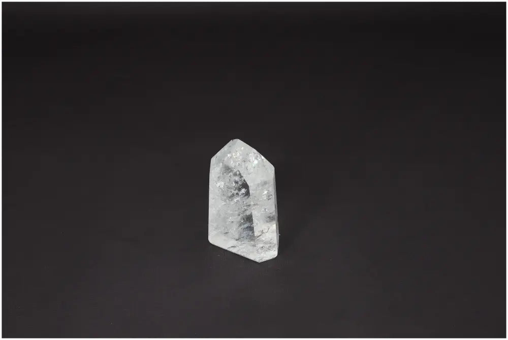 Lemurian Quartz Obelisk on dark background, known for unique properties, supporting chakras and spiritual needs; ideal for energetic healing.