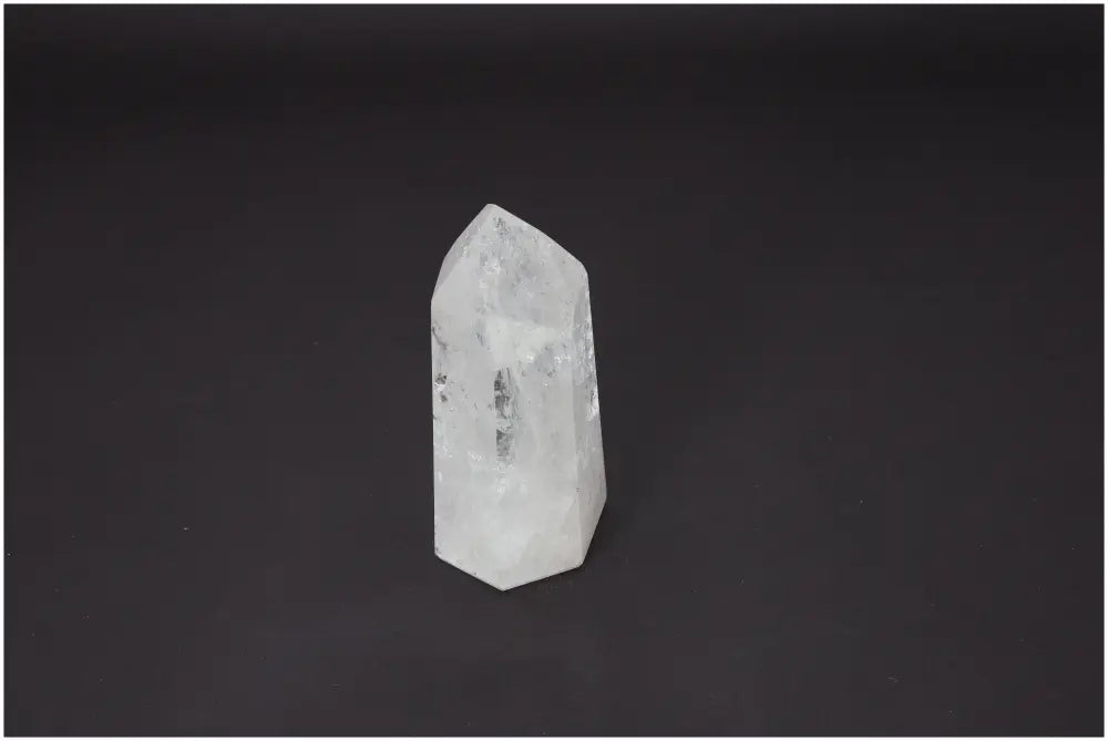 Lemurian Quartz Obelisk against a dark background, showcasing its unique crystalline structure and spiritual properties.