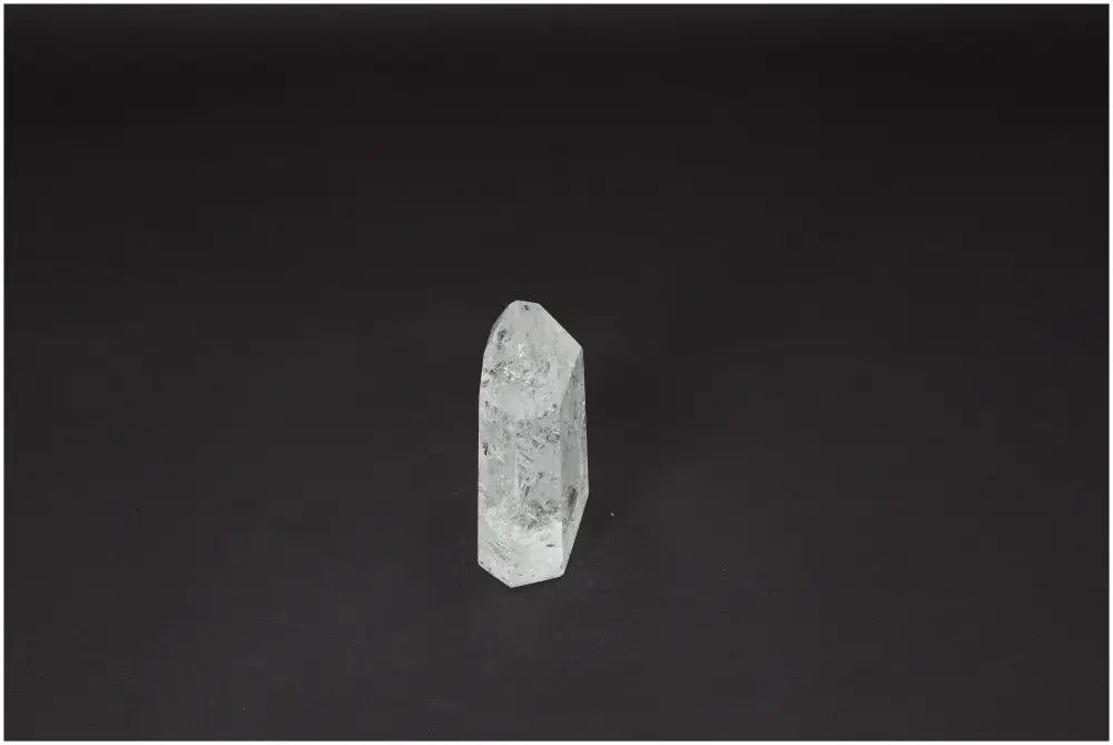 Lemurian Quartz Obelisk on dark background, showcasing unique energetic properties and spiritual significance for chakras and zodiac signs.
