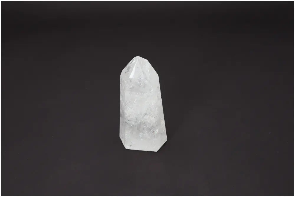 Lemurian Quartz Obelisk on a dark background, showcasing its clear, crystalline structure and spiritual energy properties.