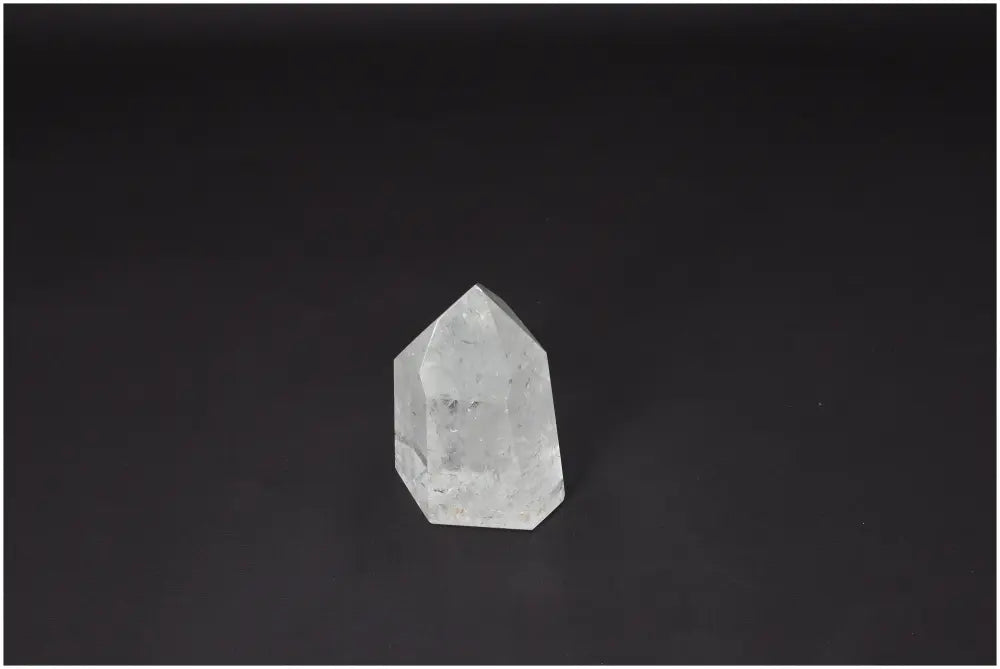 Lemurian Quartz Obelisk on dark background showcasing spiritual and energetic properties with chakra and zodiac connections.