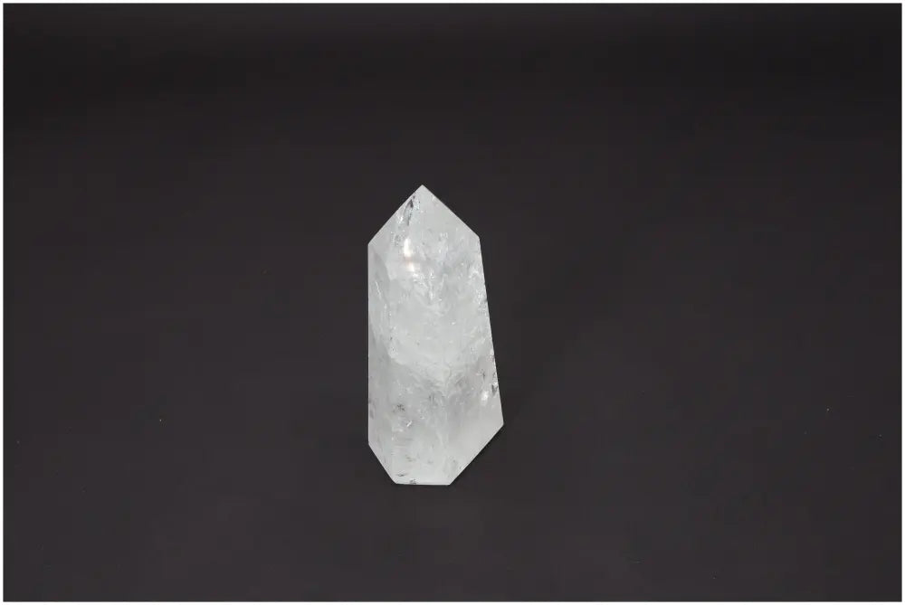 Lemurian Quartz Obelisk on a dark background, showcasing unique properties and connection to chakras and zodiac signs.
