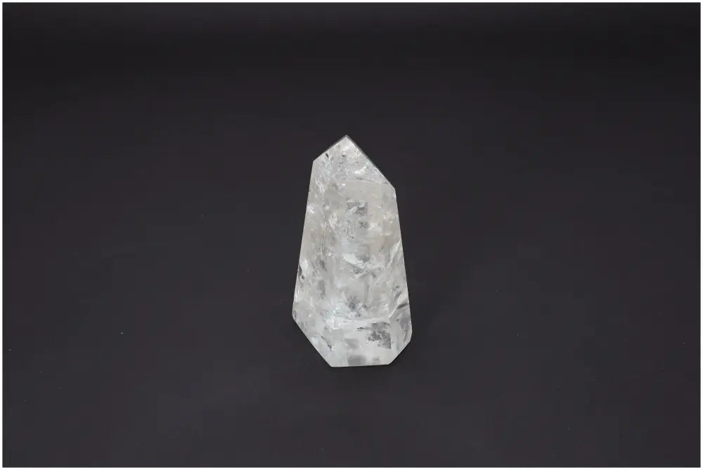 Lemurian Quartz Obelisk on dark background, known for its unique properties and connection to chakra and zodiac energies.
