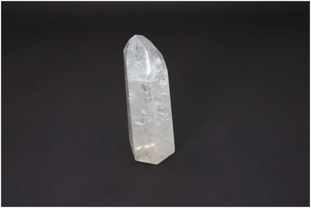 Lemurian Quartz Obelisk on black background, showcasing crystal features and transparency ideal for chakra and zodiac energy alignment.