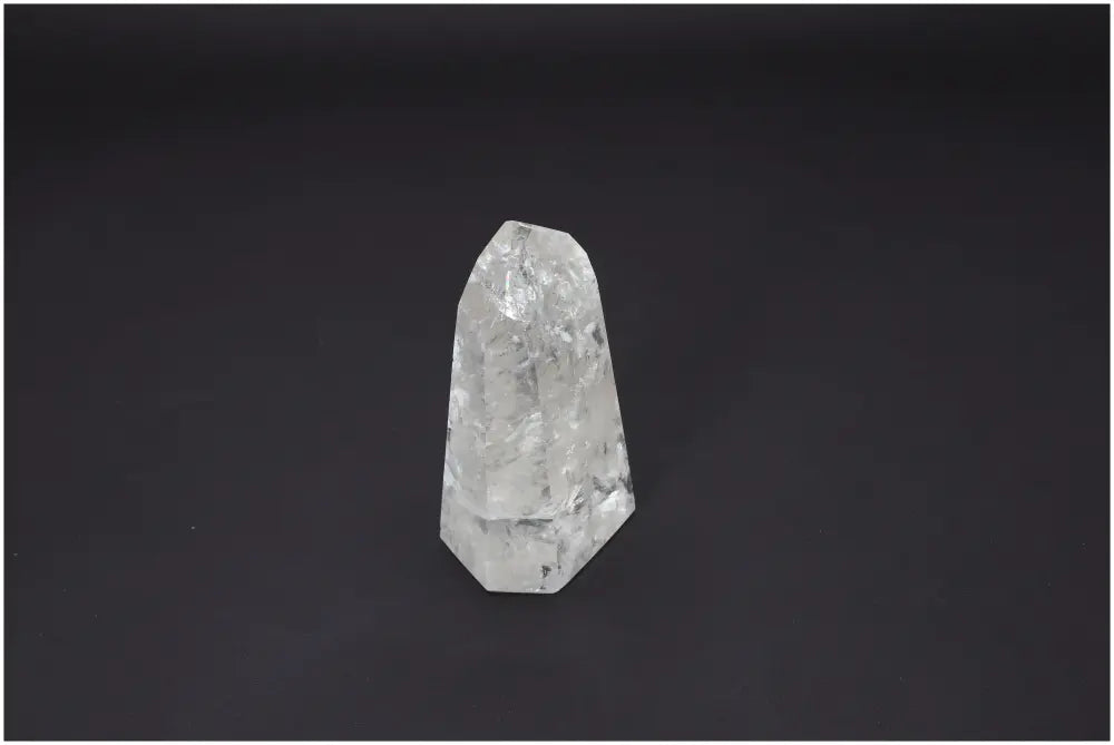Lemurian Quartz Obelisk on dark background, emphasizing its unique structure and spiritual properties for chakra alignment.