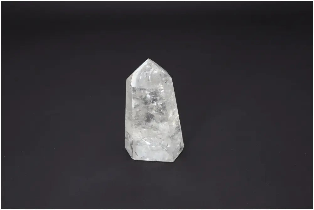 Lemurian Quartz Obelisk with unique properties for chakra alignment and spiritual enhancement on a dark background.