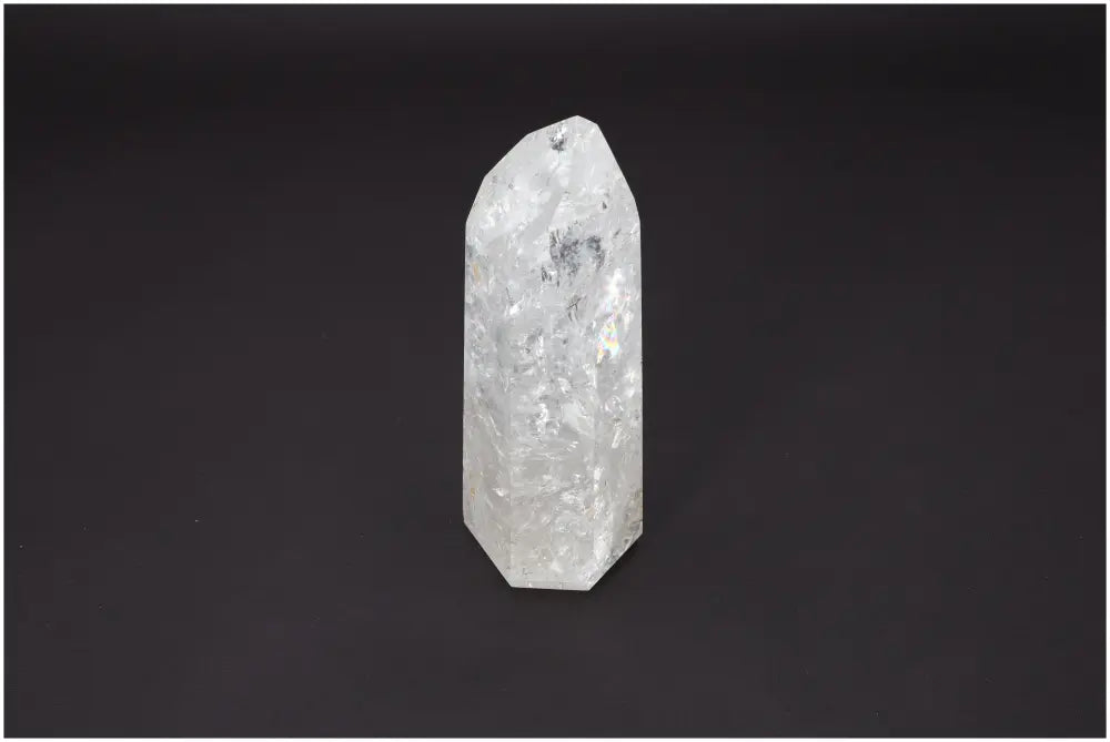 Lemurian Quartz Obelisk against dark background, highlighting clarity and spiritual properties, linked to chakras and zodiac signs.