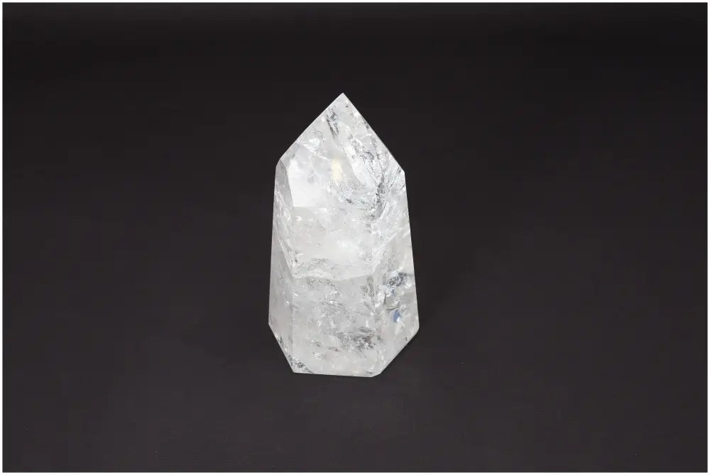 Lemurian Quartz Obelisk on black background showcasing its clear crystalline structure for chakra and zodiac energy alignment.