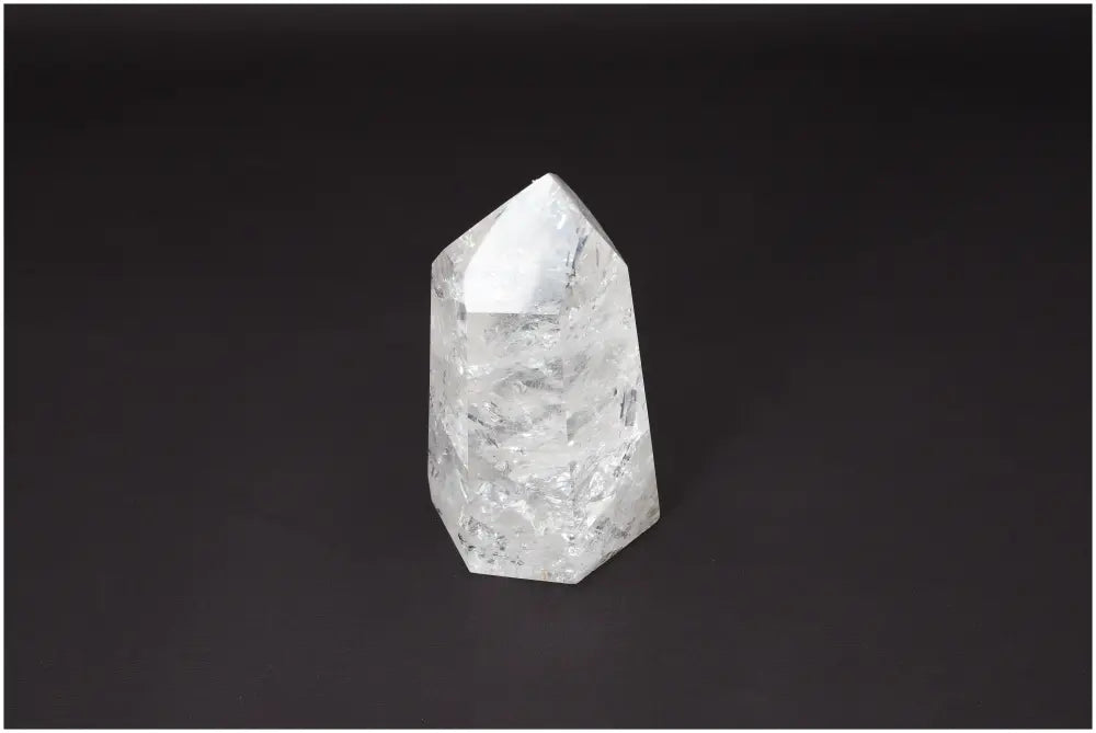 Lemurian Quartz Obelisk against a dark background, showcasing its unique crystalline structure and spiritual properties.