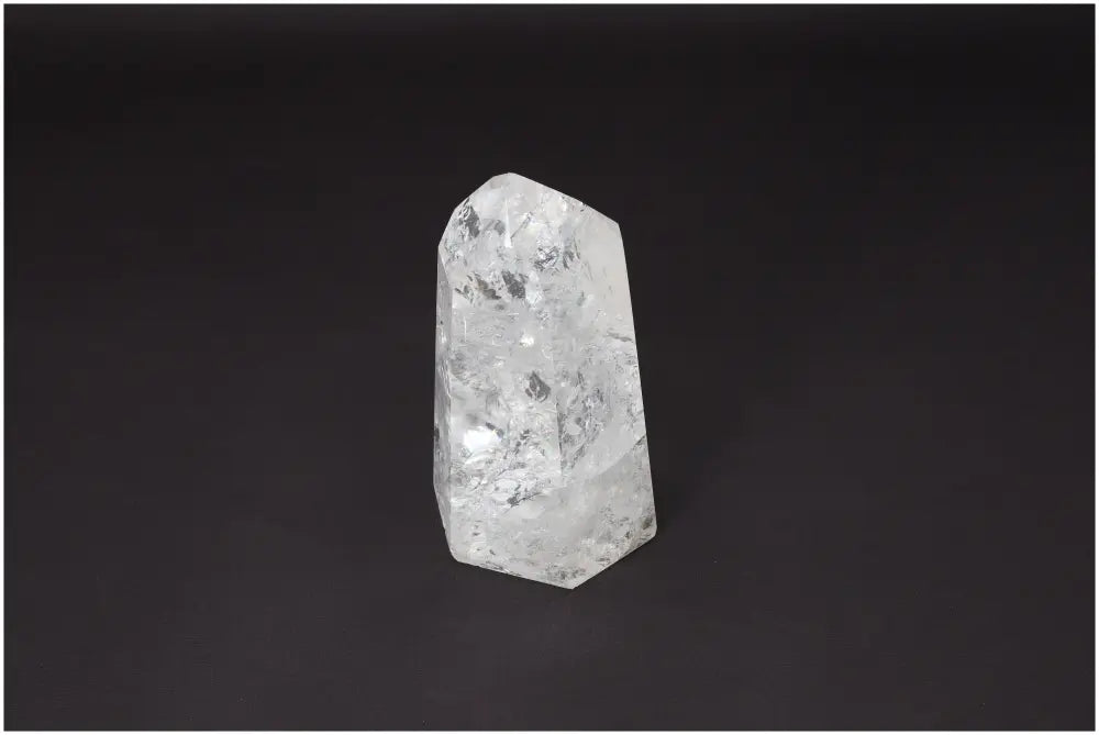 Lemurian Quartz Obelisk on dark background showcasing its unique clarity and properties for energetic and spiritual support.