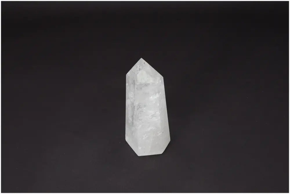 Lemurian Quartz Obelisk on black background, showcasing its clarity and natural formation, known as a "Master Healer" crystal for personal growth.