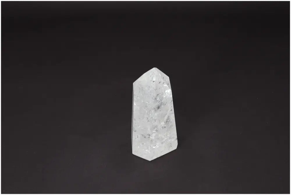 Lemurian Quartz Obelisk - hand-selected clear crystal on dark background, enhances clarity, balance, and personal growth.