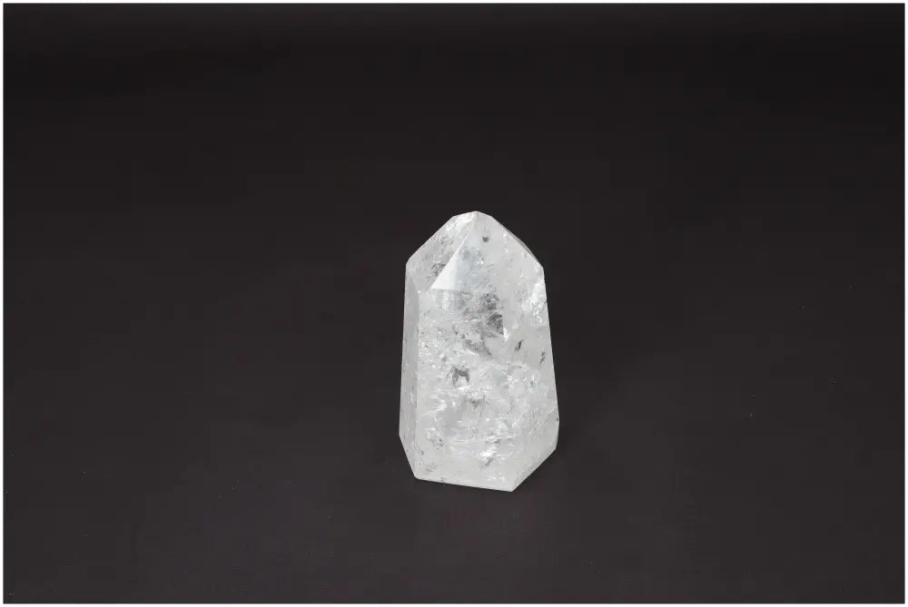 Lemurian Quartz Obelisk on black background, a clear crystal known as the 'Master Healer' that enhances clarity and balance.