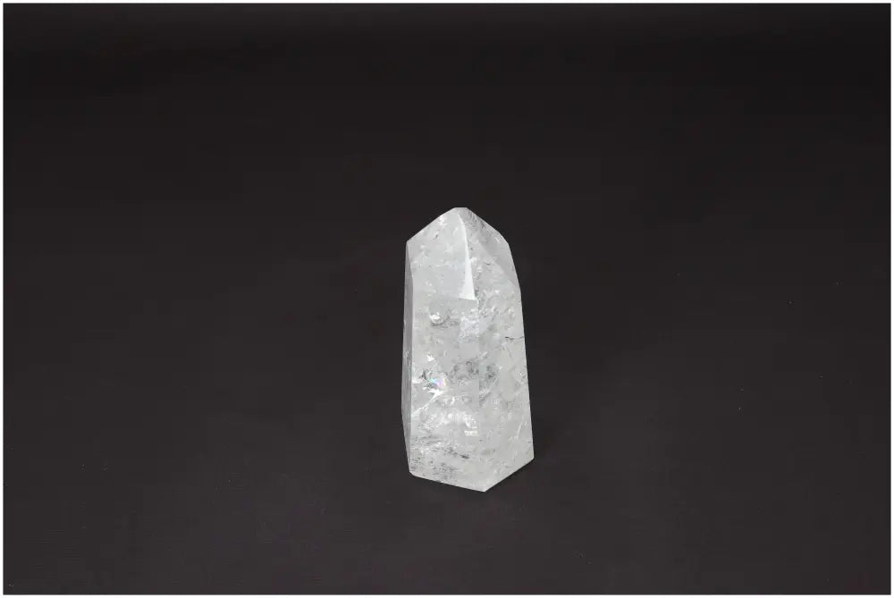 Lemurian Quartz Obelisk on black background, a clear crystal known for clarity and energy amplification, ethically sourced and hand-selected.