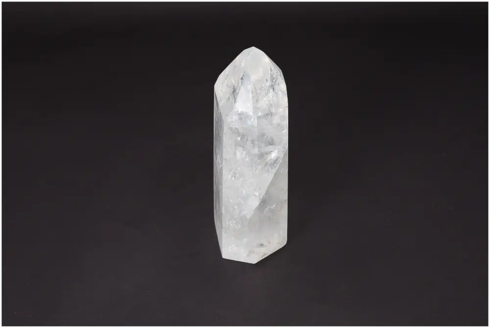 Lemurian Quartz Obelisk on dark background, known as the 'Master Healer' crystal, symbolizing clarity and balance.