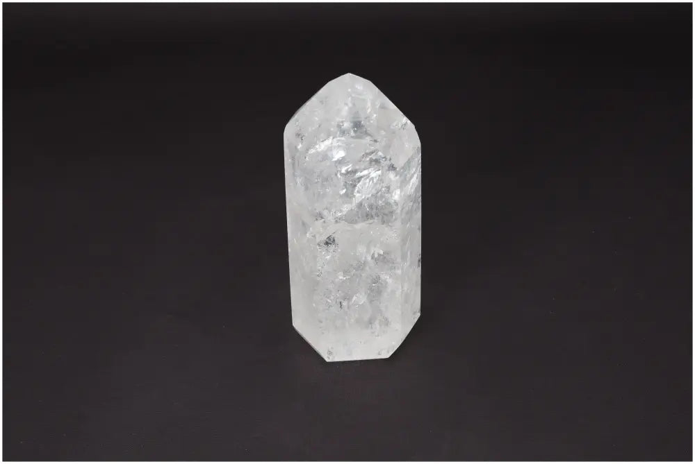 Lemurian Quartz Obelisk on dark background, known as Master Healer crystal, enhances clarity, balance, and personal growth.