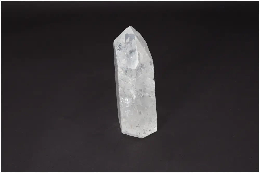 Clear Lemurian Quartz Obelisk crystal for clarity, balance, and personal growth on a dark background.