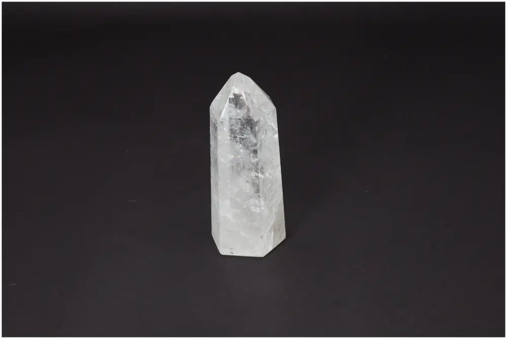 Lemurian Quartz Obelisk on dark background, showcasing clear quartz crystal for clarity and balance in personal growth.