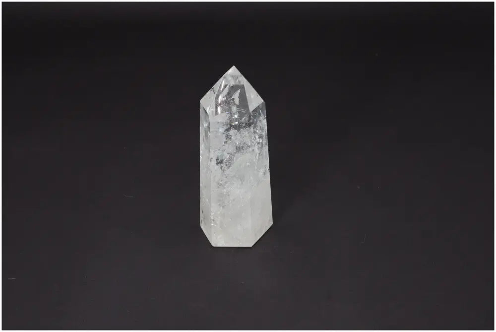 Lemurian Quartz Obelisk on dark background, known for clarity, balance, and healing energy.
