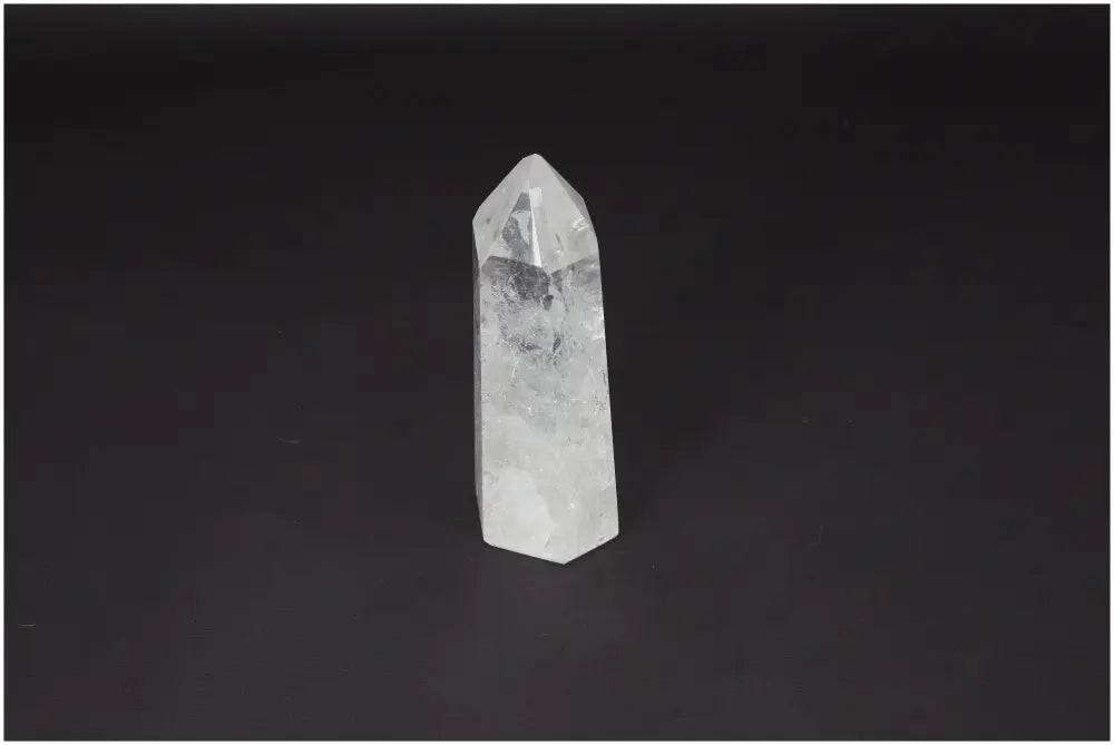 Lemurian Quartz Obelisk - Clear Quartz crystal with healing properties on a dark background, ethically sourced and naturally formed.