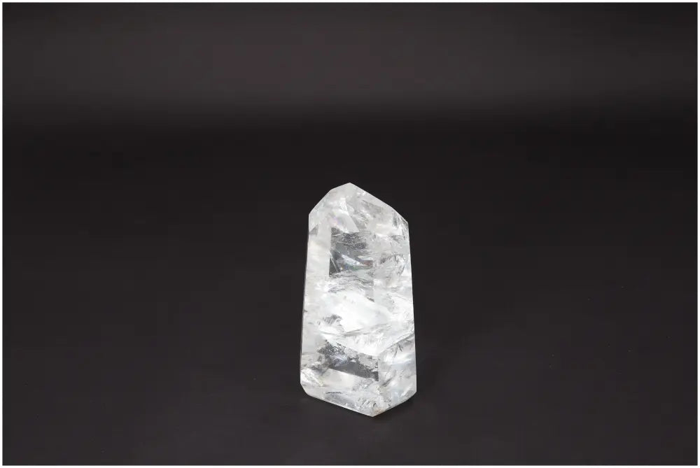 Lemurian Quartz Obelisk - Clear Quartz crystal on black background, symbolizing clarity, balance, and healing energy.
