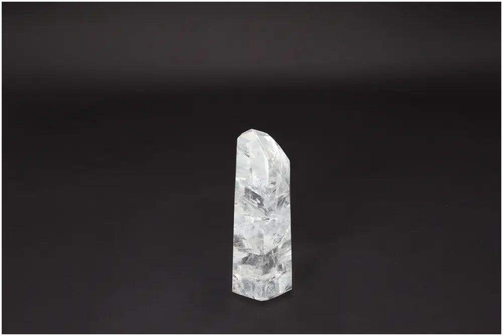 Lemurian Quartz Obelisk on dark background, clear quartz crystal for clarity and balance, hand-selected and ethically sourced.