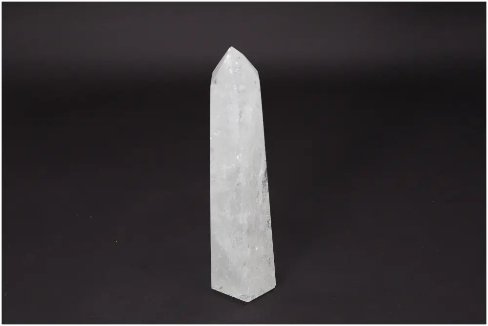 Lemurian Quartz Obelisk crystal on black background, representing clarity, balance, and personal growth through its healing properties.