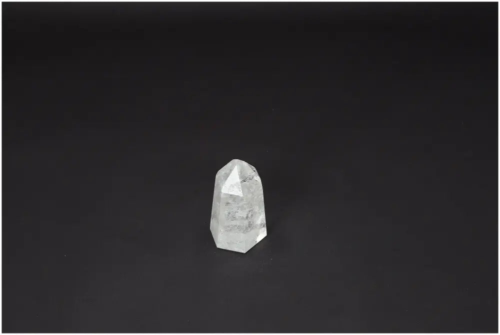 Lemurian Quartz Obelisk against dark background; Clear Quartz for clarity and balance; Master Healer crystal; ethically sourced.