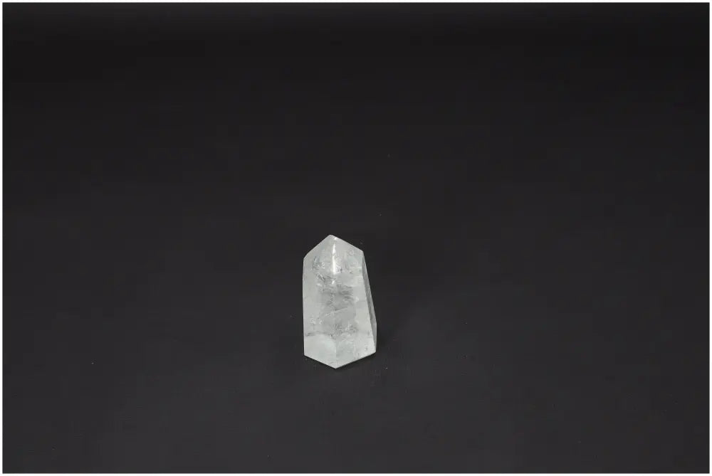 Lemurian Quartz Obelisk on dark background, showcasing its clarity and natural beauty as a Master Healer crystal for personal growth.