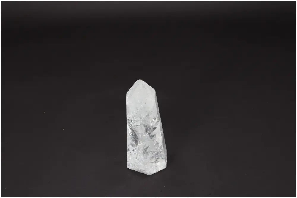 Lemurian Quartz Obelisk crystal on black background, known for enhancing clarity and balance, used in personal growth and energy healing.