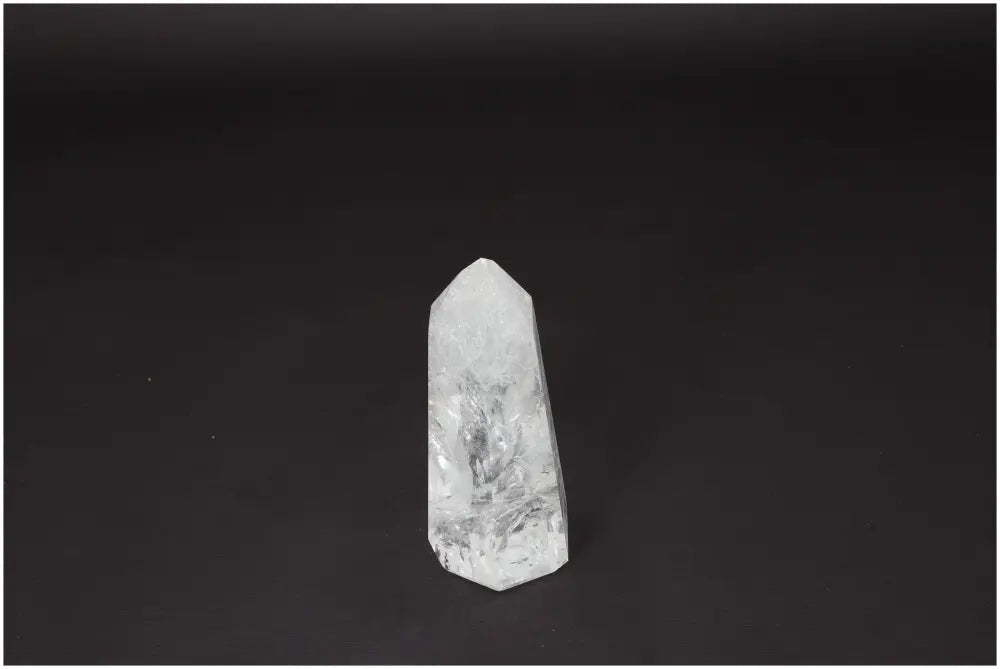 Clear Lemurian Quartz Obelisk on black background, known for enhancing clarity, balance, and personal growth. Ethically sourced crystal.