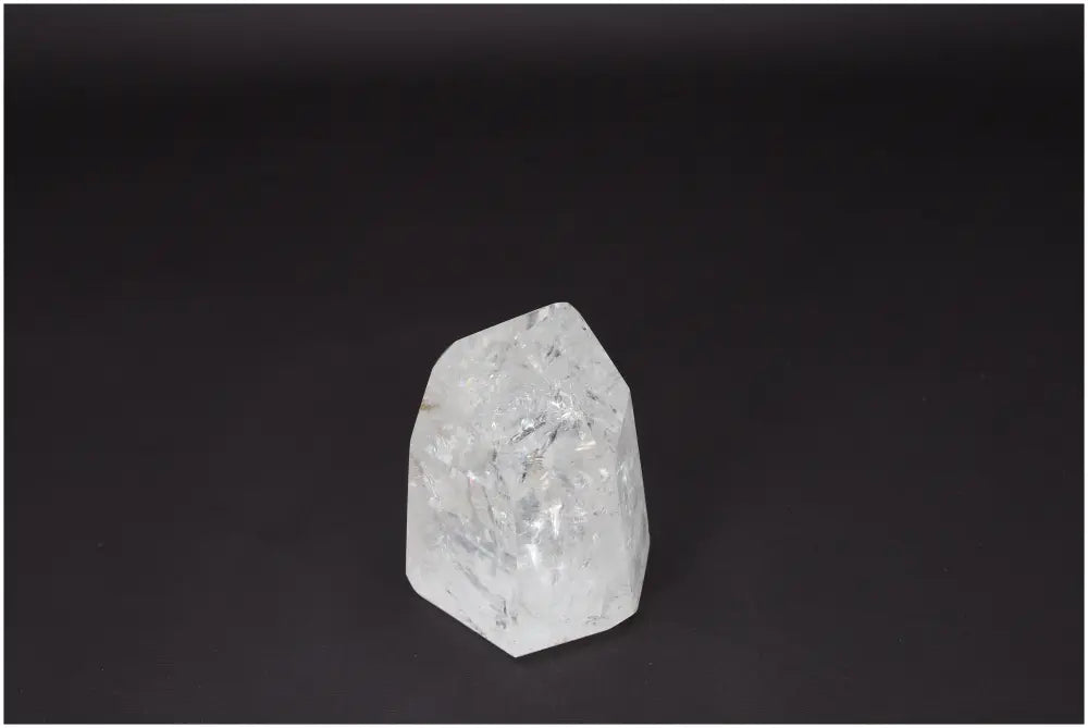 Lemurian Quartz Obelisk on black background, symbolizing clarity and balance. Ethically sourced, natural Clear Quartz crystal.