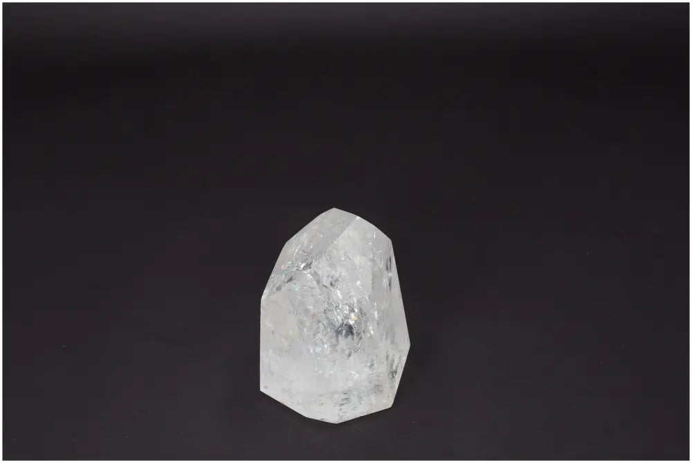 Lemurian Quartz Obelisk on dark background, highlighting its clarity and natural formation, ideal for energy amplification and healing.