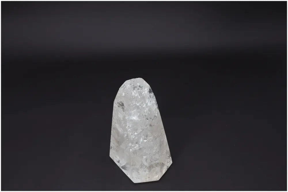 Lemurian Quartz Obelisk against a dark background, showcasing its natural clarity and crystalline structure.