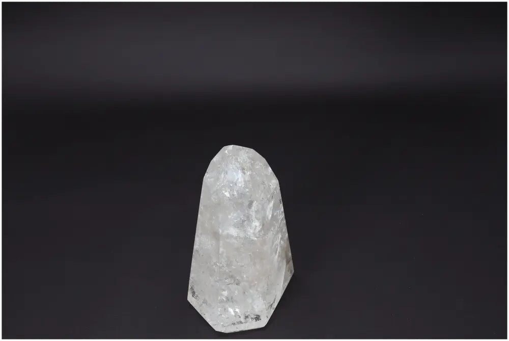 Lemurian Quartz Obelisk for clarity and balance, ethically sourced clear quartz crystal on a black background, perfect for personal growth.