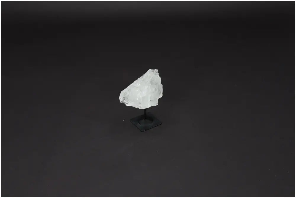 Lemurian Clear Quartz crystal on a metal stand, known for enhancing clarity, balance, and personal growth through its healing energy.