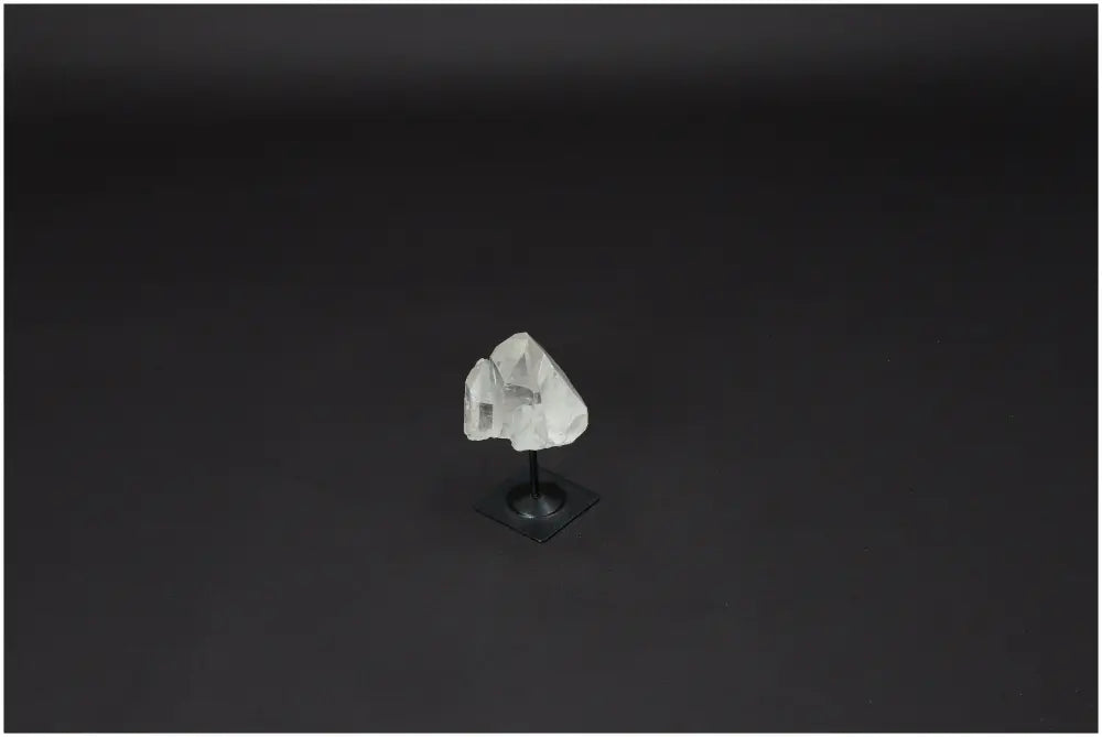 Lemurian Quartz on a sleek metal stand against a dark background, ideal for enhancing clarity and energy in your space.