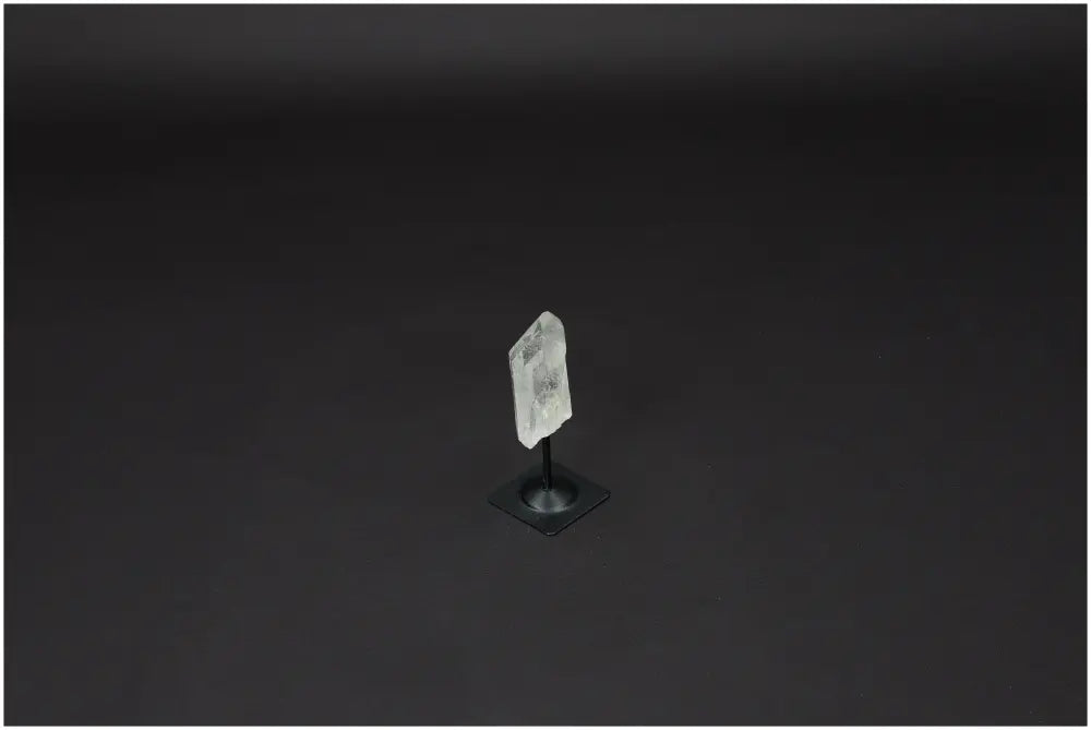 Lemurian Quartz crystal on elegant metal stand, known as the "Master Healer" for energy amplification and balance. Ethically sourced.